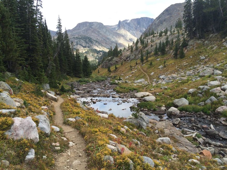In this Aug. 31, 2016 photo, the Beaten Path, a 26-mile hiking trail that crosses through Montana's Absaroka-Beartooth Wilderness, is seen against the backdrop of the wilderness high peaks, some of the most dramatic and beautiful in the entire state. (Mike Eckel via AP)