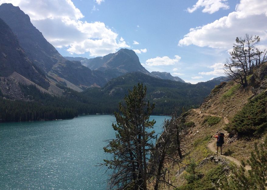 In this Aug. 30, 2016 photo, Mike Eckel hikes above a lake along the Beaten Path, a 26-mile hiking trail that crosses through Montana's Absaroka-Beartooth Wilderness. (Ben Yeomans via AP)