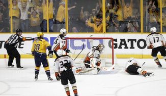 Fans celebrate after a shot by Predators defenseman Roman Josi, of Switzerland, not shown, got past Anaheim Ducks goalie John Gibson (36) for the winning goal during the third period in Game 3 of the Western Conference final in the NHL hockey Stanley Cup playoffs Tuesday, May 16, 2017, in Nashville, Tenn. Also defending for the Ducks are Sami Vatanen (45), of Finland; Jakob Silfverberg (33), of Sweden; Cam Fowler (4) and Ryan Kesler (17). The Predators won 2-1 and lead the series 2-1. (AP Photo/Mark Humphrey)