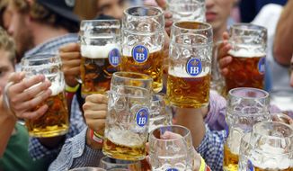 In this Sept. 19, 2015, file photo, people celebrate the opening of the 182nd Oktoberfest beer festival in Munich, Germany. (AP Photo/Matthias Schrader, File)