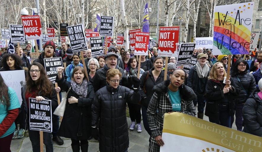 FILE - In this Feb. 17, 2017 file photo protesters chant "Free Daniel" during a demonstration, outside the federal courthouse in Seattle, where a hearing was held for Daniel Ramirez Medina, a Seattle-area man who was arrested by immigration agents despite his participation in a federal program to protect those brought to the U.S. illegally as children. On Wednesday, May 17, a federal judge in Seattle has temporarily blocked a Justice Department decision that immigrant legal rights organizations around the country say would curtail much of the work they do. (AP Photo/Ted S. Warren,File)