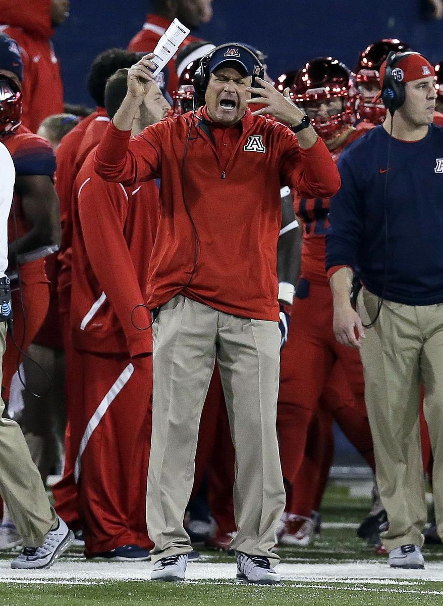 FILE - In this Nov. 25, 2016, file photo, Arizona coach Rich Rodriguez reacts after a penalty during the second half of the teams NCAA college football game against Arizona State, in Tucson, Ariz. The hot seat in college football can be defined as a coach who is danger of being fired if his team does not improve upon last season. (AP Photo/Rick Scuteri, File)