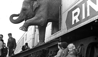 FILE - In this April 1, 1963 file photo, a Ringling Bros. Circus elephant walks out of a train car as young children watch in the Bronx railroad yard in New York. The Ringling Bros. and Barnum &amp;amp; Bailey Circus is drawing to a close in May 2017, after 146 years of performances and travel. (AP Photo)
