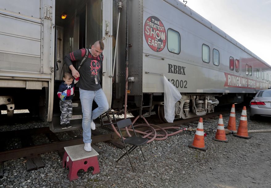 Boss clown Sandor Eke helps his 2-year-old son. Michael Eke step off the Ringling Bros. circus red unit's traveling train parked in a rail yard as they head to the arena for a show, Thursday, May 4, 2017, in Providence, R.I. Someday, he plans to teach his son juggling and other circus skills, but Eke knows he may never join the circus. Eke’s wife, a former circus aerialist, has already established their new home in Las Vegas. When the circus closes, Eke hopes to get a job as a “flair” bartender there, doing tricks like juggling bottles, but he wonders how life will change. “My normal life is this. My normal life is going on the train, going every week to a different city. It’s crazy how much I love circus,” Eke says. (AP Photo/Julie Jacobson)