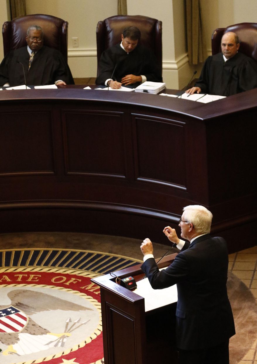 Former Gov. Ronnie Musgrove, lower right, tells the Mississippi Supreme Court in Jackson, Miss., that they should hold lawmakers to their word to spend a certain amount on schools during oral arguments Wednesday, May 17, 2017, in an appeal of a lawsuit brought by 21 school districts. Musgrove, also demanded the state pay $236 million for shorting the districts between 2010 and 2015. The districts also want judges to order the Legislature to never underfund the formula again. (AP Photo/Rogelio V. Solis)