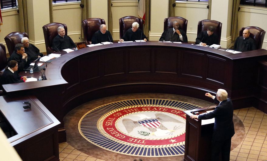 Former Gov. Ronnie Musgrove, lower right, tells the Mississippi Supreme Court in Jackson, Miss., that they should hold lawmakers to their word to spend a certain amount on schools during oral arguments Wednesday, May 17, 2017, in an appeal of a lawsuit brought by 21 school districts. Musgrove, also demanded the state pay $236 million for shorting the districts between 2010 and 2015. The districts also want judges to order the Legislature to never underfund the formula again. (AP Photo/Rogelio V. Solis)