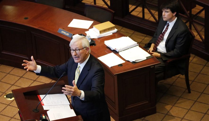 Special Assistant Attorney General Justin Matheny, defending the state, right, listens as former Gov. Ronnie Musgrove tells the Mississippi Supreme Court in Jackson, Miss., that they should hold lawmakers to their word to spend a certain amount on schools during oral arguments Wednesday, May 17, 2017, in an appeal of a lawsuit brought by 21 school districts. Musgrove, representing the school districts, also demanded the state pay $236 million for shorting the districts between 2010 and 2015. The districts also want judges to order the Legislature to never underfund the formula again. (AP Photo/Rogelio V. Solis)