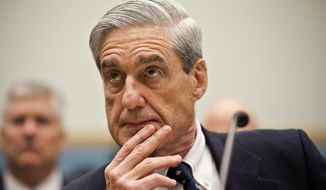 In this June 13, 2012, file photo, then-FBI Director Robert Mueller listens as he testifies on Capitol Hill in Washington. (AP Photo/J. Scott Applewhite, File)