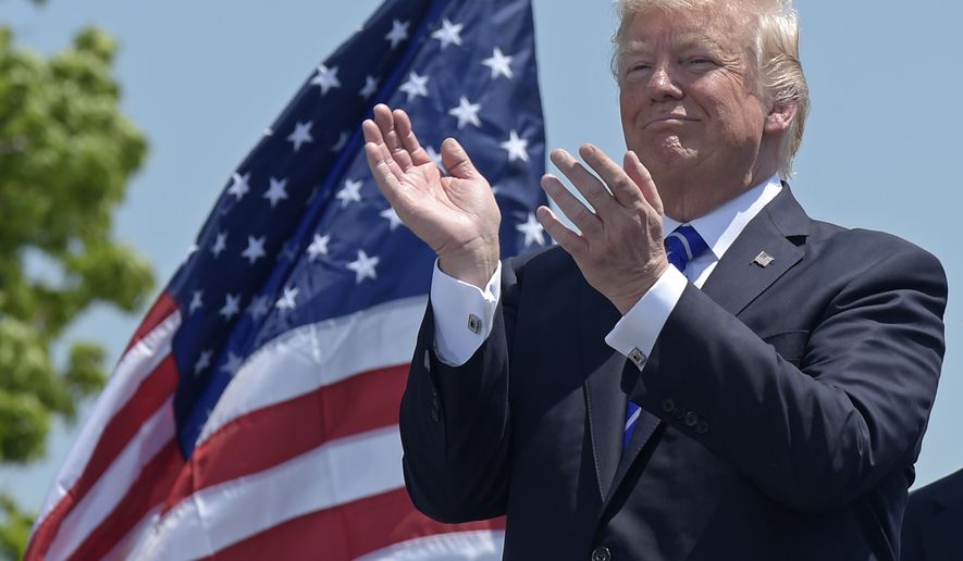 President Donald Trump applauds at the commencement exercises at the U.S. Coast Guard Academy in New London, Conn., Wednesday, May 17, 2017, where he also gave the commencement address. (AP Photo/Susan Walsh)