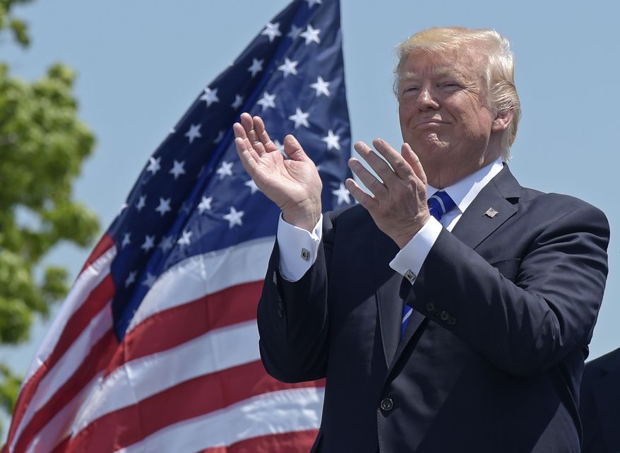 President Donald Trump applauds at the commencement exercises at the U.S. Coast Guard Academy in New London, Conn., Wednesday, May 17, 2017, where he also gave the commencement address. (AP Photo/Susan Walsh)
