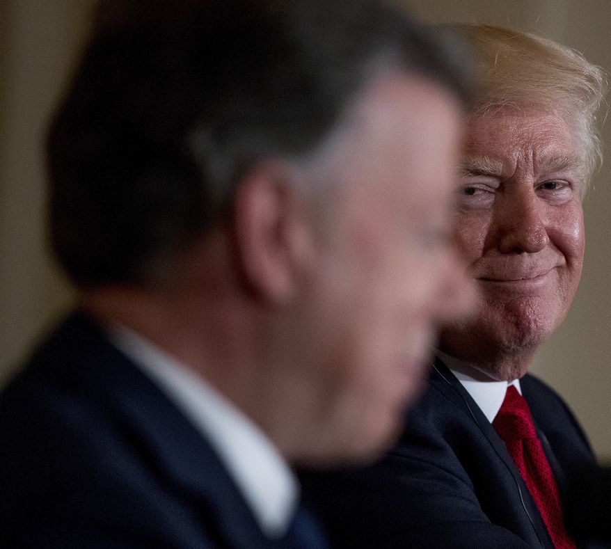 President Donald Trump smiles as he listens to Colombian President Juan Manuel Santos, speak during a news conference in the East Room of the White House, Thursday, May 18, 2017, in Washington. (AP Photo/Andrew Harnik)