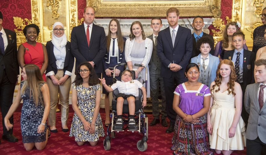 Britain's Prince Harry, center right, and Prince William pose for photographers with the award winners during a ceremony for The Diana Award's inaugural Legacy Award, at St James' Palace in London, Thursday, May 18, 2017. The awards, in honor of Princess Diana, were given to twenty exceptional young people from across the world for their qualities of kindness, compassion and service. (Paul Grover/Pool Photo via AP)