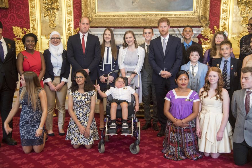 Britain's Prince Harry, center right, and Prince William pose for photographers with the award winners during a ceremony for The Diana Award's inaugural Legacy Award, at St James' Palace in London, Thursday, May 18, 2017. The awards, in honor of Princess Diana, were given to twenty exceptional young people from across the world for their qualities of kindness, compassion and service. (Paul Grover/Pool Photo via AP)