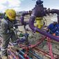 Workers tend to a well head during a hydraulic fracturing operation outside Rifle, in western Colorado on March 29, 2013. (Associated Press) **FILE**