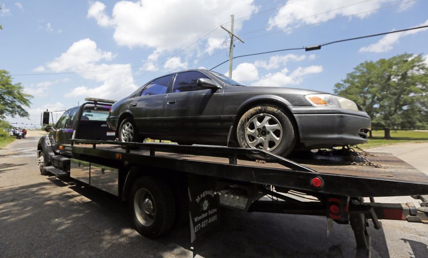 A Mississippi Highway Patrol tow truck hauls away a vehicle from a dead end road in Gluckstadt, Miss., Thursday morning, May 18, 2017, where 6-year-old Kingston Frazier was shot to death after the car he was riding in was stolen early, from a grocery store parking lot in Jackson. (AP Photo/Rogelio V. Solis)