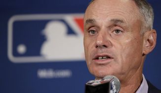 FILE - In this Feb. 21, 2017, file photo, Major League Baseball Commissioner Rob Manfred answers questions at a news conference in Phoenix. On March 9, 2018, MLB announced a deal with Facebook to stream 25 afternoon games in the 2018 season. (AP Photo/Morry Gash, File)