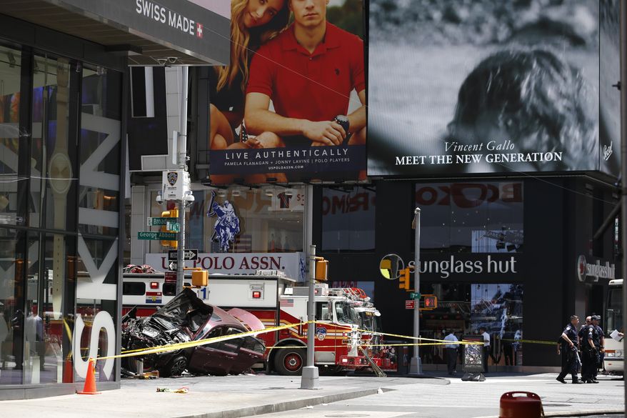 A smashed car sits on the corner of Broadway and 45th Street in New York's Times Square after ploughing through a crowd of pedestrians at lunchtime on Thursday, May 18, 2017. Police do not suspect a link to terrorism and the driver was taken into custody to be tested for alcohol. (AP Photo/Seth Wenig)
