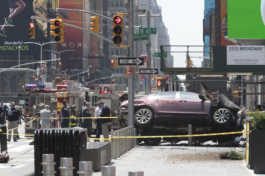 A car rests on a security barrier in New York's Times Square after driving through a crowd of pedestrians, injuring at least a dozen people, Thursday, May 18, 2017. (AP Photo/Mary Altaffer)