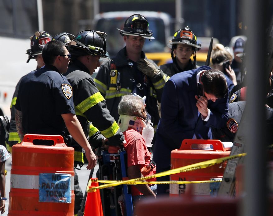 Emergency personnel treat a victim after a car ploughed through a crowd of pedestrians during lunchtime at New York's Times Square, Thursday, May 18, 2017. Police do not suspect a link to terrorism and the driver was taken into custody to be tested for alcohol. (AP Photo/Seth Wenig)
