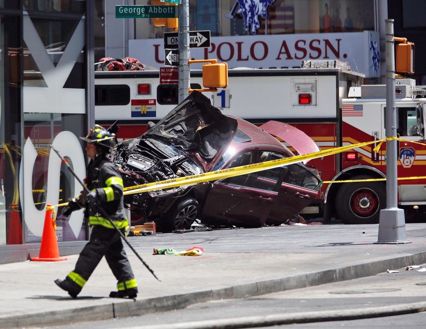 A smashed car sits on the corner of Broadway and 45th Street in New York's Times Square after ploughing through a crowd of pedestrians at lunchtime on Thursday, May 18, 2017. Police do not suspect a link to terrorism and the driver was taken into custody to be tested for alcohol. (AP Photo/Seth Wenig)