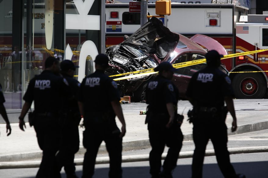 A smashed car sits on the corner of Broadway and 45th Street in New York's Times Square after ploughing through a crowd of pedestrians at lunchtime on Thursday, May 18, 2017. Police do not suspect a link to terrorism and the driver was taken into custody to be tested for alcohol. (AP Photo/Seth Wenig)