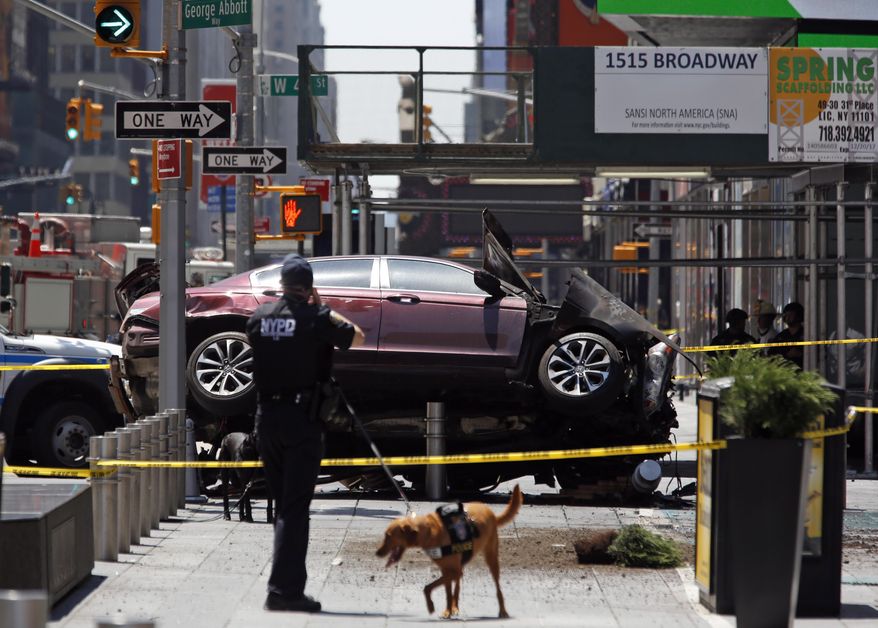 A smashed car sits on the corner of Broadway and 45th Street in New York's Times Square after ploughing through a crowd of pedestrians at lunchtime on Thursday, May 18, 2017. Police do not suspect a link to terrorism and the driver was taken into custody to be tested for alcohol. (AP Photo/Seth Wenig)