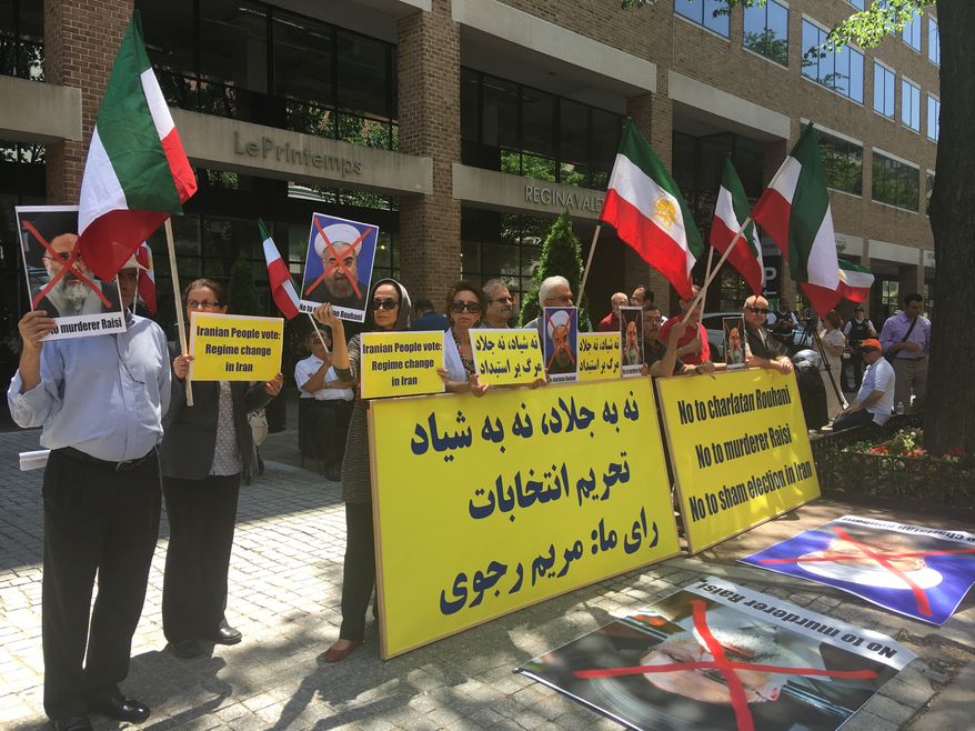 Protestors shout slogans and hold signs against Iranian elections outside the Special Interest Section of the Iranian Embassy in Washington D.C. on Friday. (Laura Kelly)