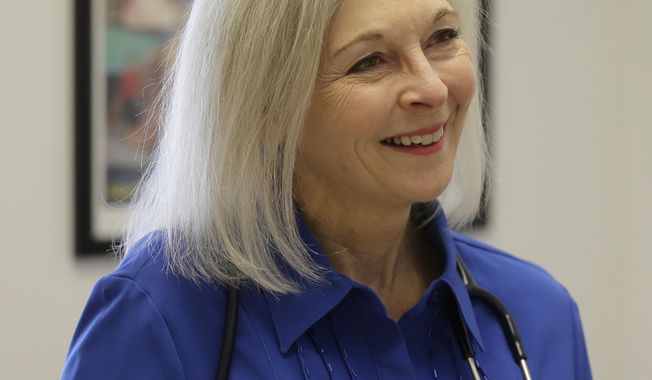 FILE-In this March 14, 2017, file photo, Utah democratic U.S. House candidate Dr. Kathryn Allen speaks during an interview at a clinic in Salt Lake City. A doctor, lawyer and handful of elected officials are among the many Republican and Democratic candidates who have announced they're jumping in the race for Rep. Jason Chaffetz's seat. At least two democrats, including Allen, have also jumped in. (AP Photo/Rick Bowmer, file)