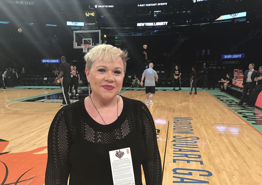 Holly Rowe stands on the court at Madison Square Garden in New York before a WNBA basketball game between the New York Liberty and the Minnesota Lynx, Thursday, May 18, 2017. Rowe was back on the sidelines for her first WNBA game of the season Thursday night. Dashing for interviews with coaches between quarters or talking to NBA Commissioner Adam Silver, who attend the game, Rowe was in her element. It was a welcome reprieve for her from her bout with melanoma which has recurred and spread. Earlier in the day, ESPN announced that it had re-signed Rowe to a multiyear contract extension. She was worried she be one of the people ESPN let go last month. (AP Photo/Doug Feinberg)