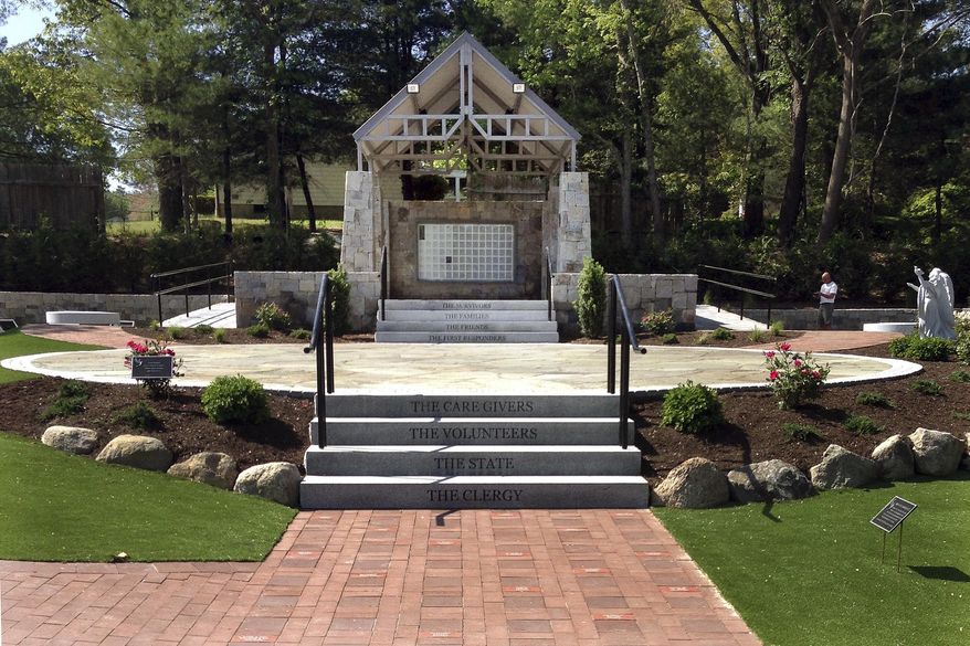 Workers finalize details at a memorial in West Warwick, R.I., on Friday, May 19, 2017, at the site of The Station nightclub fire that killed 100 and injured more than 200 people in 2003. The memorial is scheduled to open during a ceremony Sunday. (AP Photo/Michelle R. Smith)