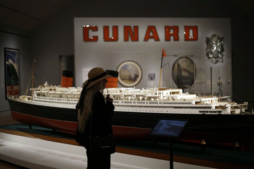 In this May 18, 2017 photo, a visitor looks at a model of the Queen Elizabeth at an exhibition entitled "Ocean Liners: Glamour, Speed, and Style" at the Peabody Essex Museum, in Salem, Mass. The new exhibition of more than 200 artworks from around the globe pays homage to the ocean liner era. (AP Photo/Elise Amendola)