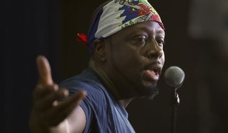 In this, Friday, May 19, 2017 photo, Haitian-American hip-hop star Wyclef Jean gestures as he speaks during a news conference at the Little Haiti Cultural Center in Miami. (AP Photo/Wilfredo Lee)