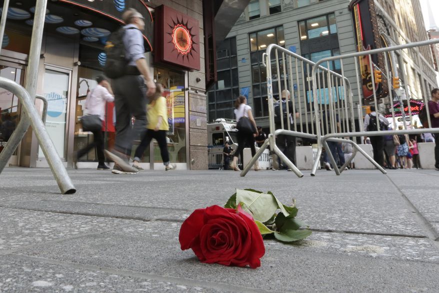 A single rose is left on the sidewalk to honor a victim of a wrong way driver in New York's Times Square, Friday, May 19, 2017. Richard Rojas, 26, charged with slamming his speeding car into pedestrians on the sidewalks of Times Square, killing a teenage tourist and injuring nearly two dozen people, said he wanted to "kill them all" and police should have shot him to stop him, a prosecutor revealed Friday. (AP Photo/Richard Drew)