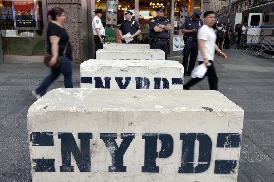 Pedestrians navigate concrete barriers in New York's Times Square, Friday, May 19, 2017.  Richard Rojas, 26, charged with slamming his speeding car into pedestrians on the sidewalks of Times Square, killing a teenage tourist and injuring nearly two dozen people, said he wanted to "kill them all" and police should have shot him to stop him, a prosecutor revealed Friday. (AP Photo/Richard Drew)