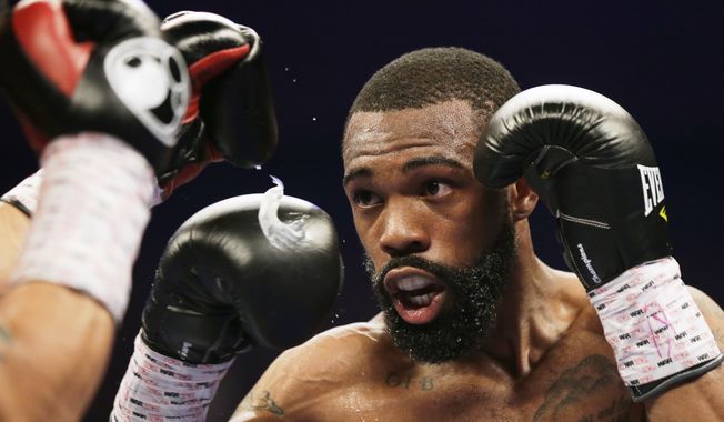 Gary Russell Jr. prepares to throw a jab at Oscar Escandon during the WBC featherweight title fight in Oxon Hill, Md., Saturday, May 20, 2017. (AP Photo/Mark Tenally)