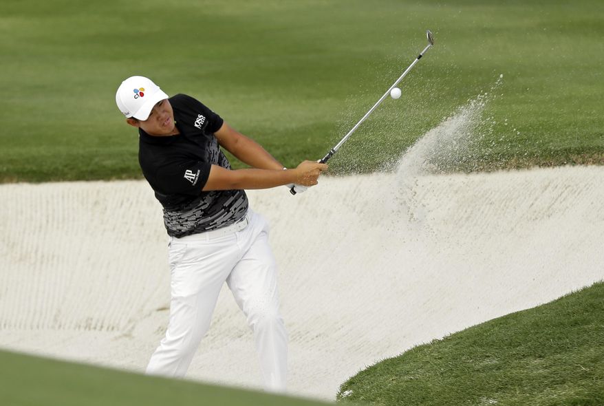 Byeong Hun An, of South Korea, hits out of a sand trap to the 18th green during the third round of the Byron Nelson golf tournament, Saturday, May 20, 2017, in Irving, Texas. (AP Photo/Tony Gutierrez)