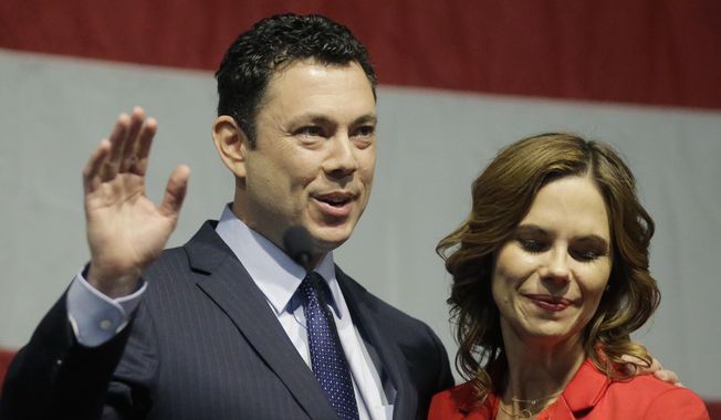 U.S. Rep. Jason Chaffetz waves to the Utah GOP Convention while his wife Julie looks on Saturday, May 20, 2017, in Sandy, Utah. Chaffetz said this week that he's stepping aside from Congress next month during the prime of his career and just as his committee was poised to investigate President Donald Trump's firing of FBI Director James Comey.  (AP Photo/Rick Bowmer)