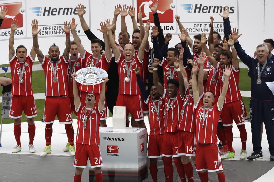 Bayern&#x27;s Philipp Lahm lifts the trophy as his team celebrate winning the Bundesliga title after the German first division Bundesliga soccer match between FC Bayern Munich and SC Freiburg at the Allianz Arena stadium in Munich, Germany, Saturday, May 20, 2017. (AP Photo/Matthias Schrader)