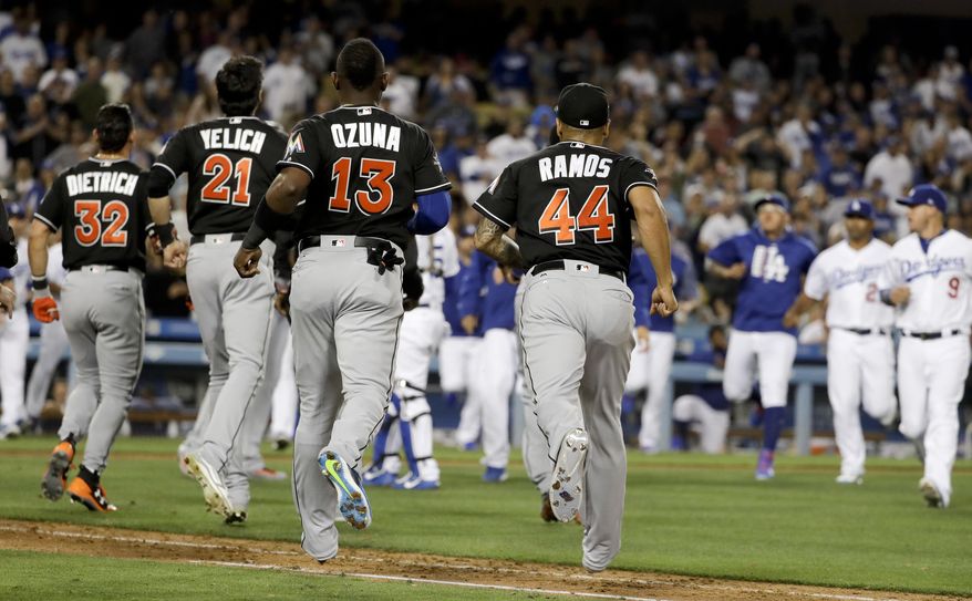 The benches empty during the eighth inning after Miami Marlins' Giancarlo Stanton was almost hit by a Los Angeles Dodgers pitch, at a baseball game in Los Angeles, Friday, May 19, 2017. (AP Photo/Chris Carlson)