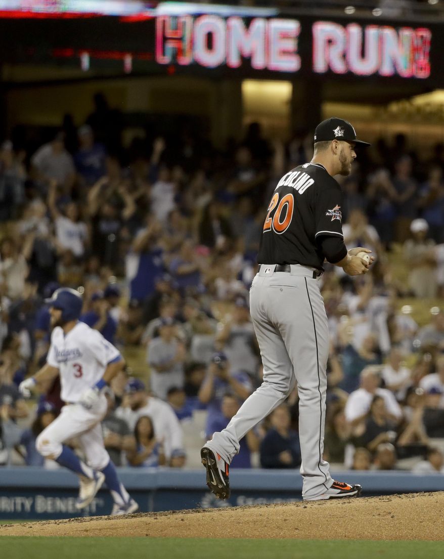 Los Angeles Dodgers' Chris Taylor, left, rounds the bases after a home run off Miami Marlins starting pitcher Justin Nicolino during third inning of a baseball game in Los Angeles, Friday, May 19, 2017. (AP Photo/Chris Carlson)