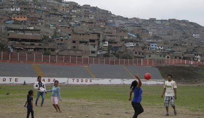 In this May 14, 2017 photo, people play ball inside of the venue that will host baseball, softball, archery and other sports during the 2019 Pan American Games in Lima, Peru. Peru is organizing the largest sports event in its history, in the wake of the worst flooding in its history. (AP Photo/Martin Mejia)
