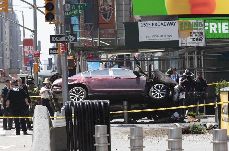 FILE - In this Thursday, May 18, 2017 file photo, a car rests on a security barrier in New York's Times Square after driving through a crowd of pedestrians, injuring at least a dozen people. A three-foot-tall piece of stainless steel in the ground ultimately stopped a speeding Honda Accord as it barreled down the crowded sidewalks of Times Square this week. In the wake of the rampage, some New Yorkers are calling for the installation of more protective bollards at the ends of city sidewalks to prevent similar incidents. (AP Photo/Mary Altaffer, File)