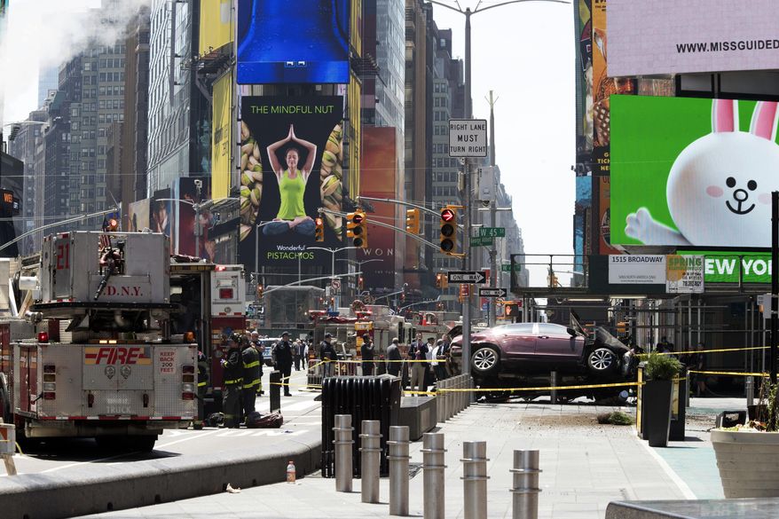 FILE - In this Thursday, May 18, 2017 photo, a car rests on a security barrier in New York's Times Square after driving through a crowd of pedestrians, injuring at least a dozen people. A three-foot-tall piece of stainless steel in the ground ultimately stopped a speeding Honda Accord as it barreled down the crowded sidewalks of Times Square this week. In the wake of the rampage, some New Yorkers are calling for the installation of more protective bollards at the ends of city sidewalks to prevent similar incidents.  (AP Photo/Mary Altaffer, File)
