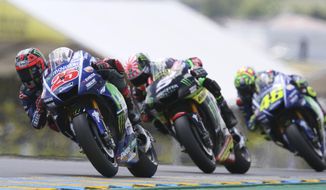 MotoGP rider Maverick Vinales of Spain steers his motorcycle as he is followed by Johann Zarco of France and Valentino Rossi of Italy during the French Grand Prix&#39;s race, in Le Mans, western France, Sunday, May 21, 2017. (AP Photo/David Vincent)