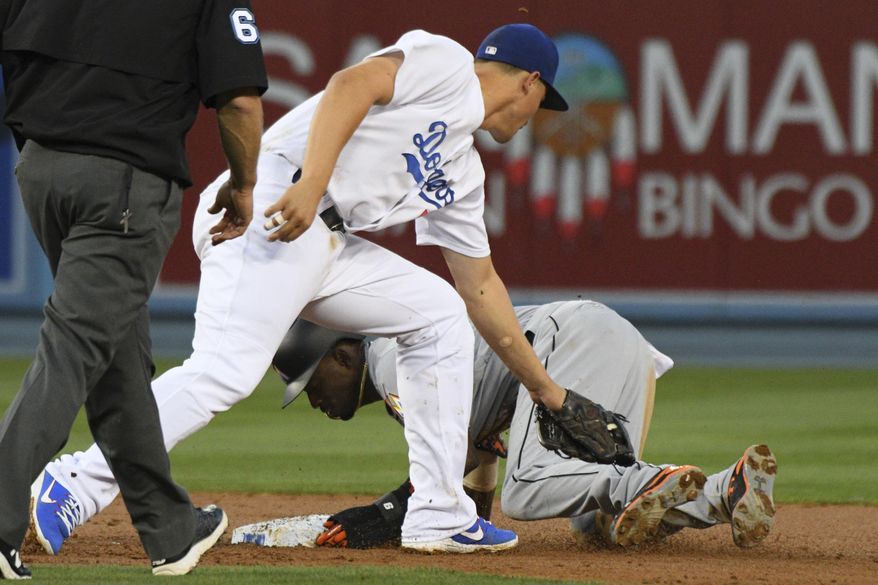 Miami Marlins' Dee Gordon steals second as Los Angeles Dodgers shortstop Corey Seager applies a late tae during the second inning of a baseball game in Los Angeles, Saturday, May 20, 2017. (AP Photo/Michael Owen Baker)