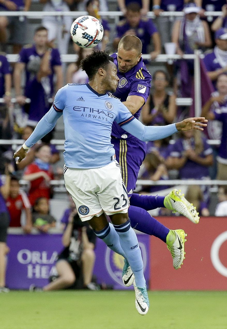 New York City FC's Rodney Wallace, left, and Orlando City's Scott Sutter, right, try to head the ball to a teammate for possession during the first half of an MLS soccer game, Sunday, May 21, 2017, in Orlando, Fla. (AP Photo/John Raoux)