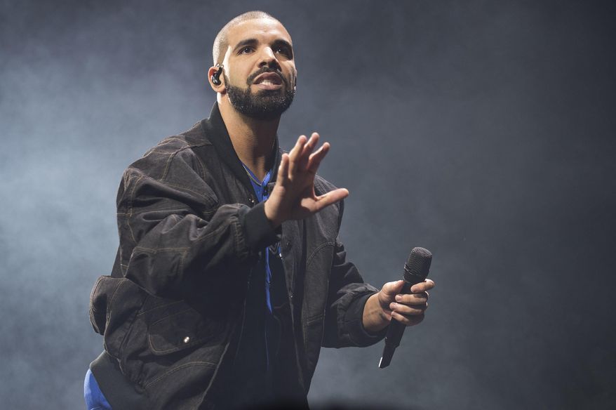 FILE - In this Oct. 8, 2016 file photo, Drake performs on stage in Toronto, Canada. Drake and the Chainsmokers are on track to own the night at the 2017 Billboard Music Awards on Sunday, May 21, in Las Vegas. The rapper and electronic dance duo are the top contenders at Sunday’s show with 22 nominations each. (Photo by Arthur Mola/Invision/AP, File)