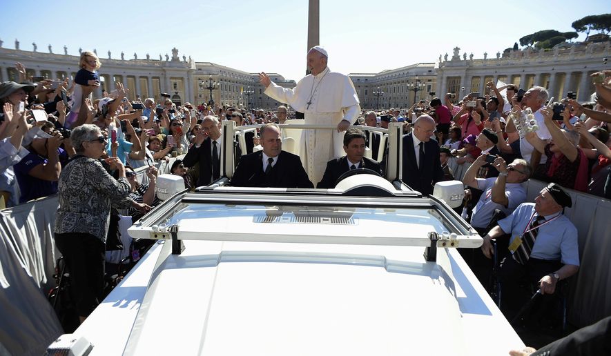 Pope Francis waves to the crowd during his weekly general audience, in St. Peter&#39;s Square at the Vatican, Wednesday, May 17, 2017. (L&#39;Osservatore Romano/Pool Photo via AP)