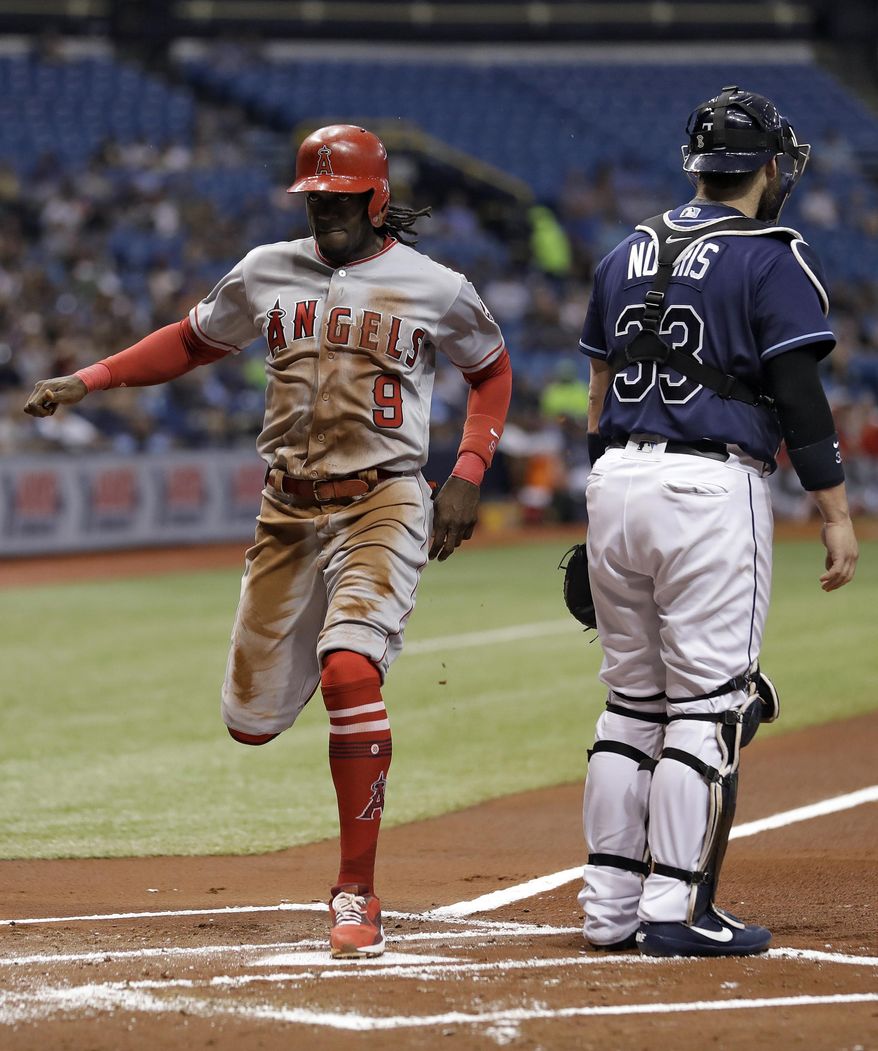 Los Angeles Angels&#39; Cameron Maybin (9) races home to score in front of Tampa Bay Rays catcher Derek Norris on a sacrifice fly by Andrelton Simmons during the first inning of a baseball game, Monday, May 22, 2017, in St. Petersburg, Fla. (AP Photo/Chris O&#39;Meara)