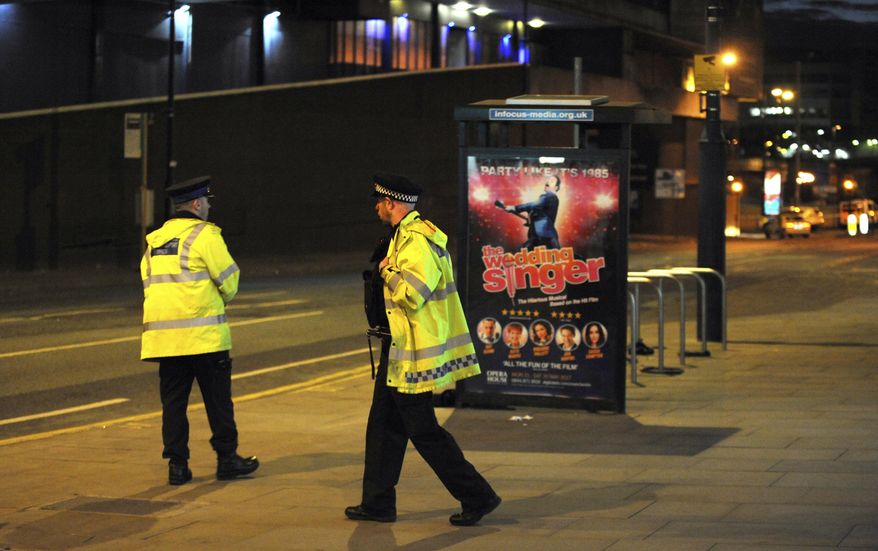 Police block a road near to the Manchester Arena in central Manchester, England Tuesday, May 23, 2017. An explosion struck an Ariana Grande concert in northern England late Monday, killing over a dozen people and injuring dozens in what police say they are treating as a terrorist attack. (AP Photo/Rui Vieira)